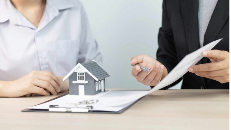This image shows a mortgage broker in Bend, Oregon, guiding a client through the process of signing an FHA loan contract.