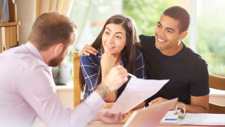 This image shows a mortgage broker in Bend, Oregon, guiding clients through the process of securing a VA home loan. VA Mortgage