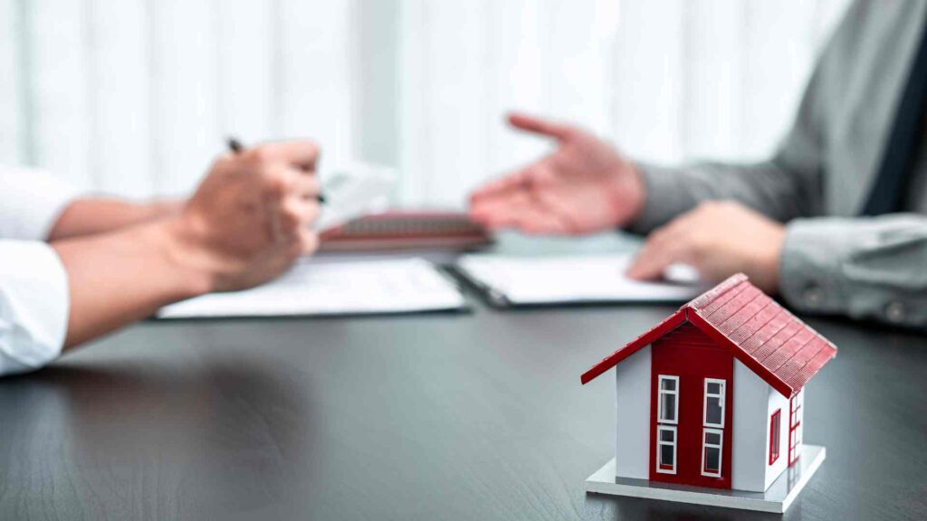This image shows a mortgage broker in Bend, Oregon, explaining loan terms to a client.